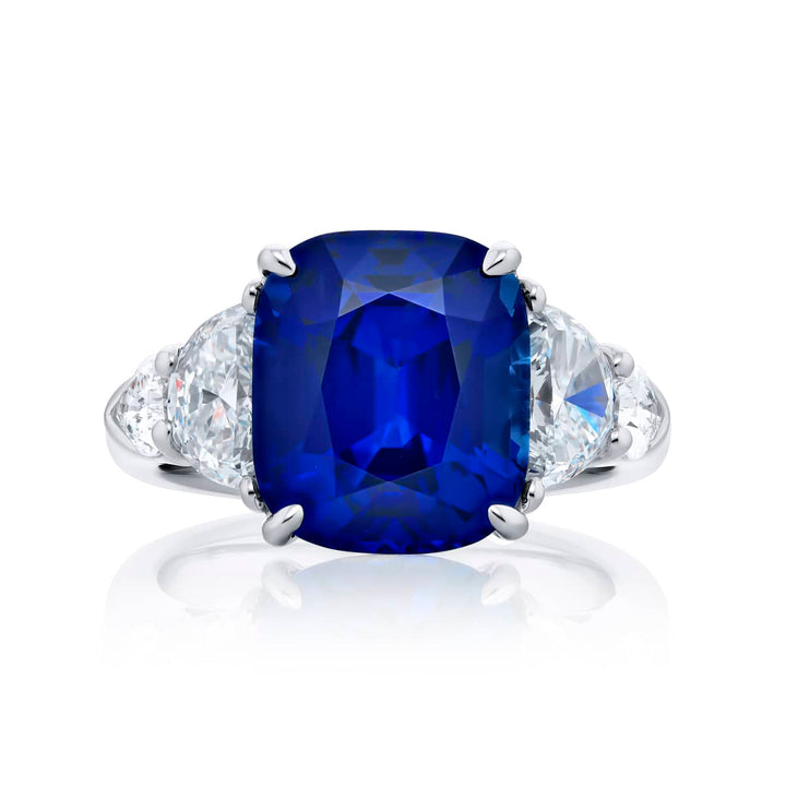 Breathtaking Radiance: Our stunning 7.04 ct. certified Sri Lankan Sapphire Ring. This beautiful cushion-cut sapphire crowned in dazzling shield and half-moon diamonds is handcrafted in pure platinum.
