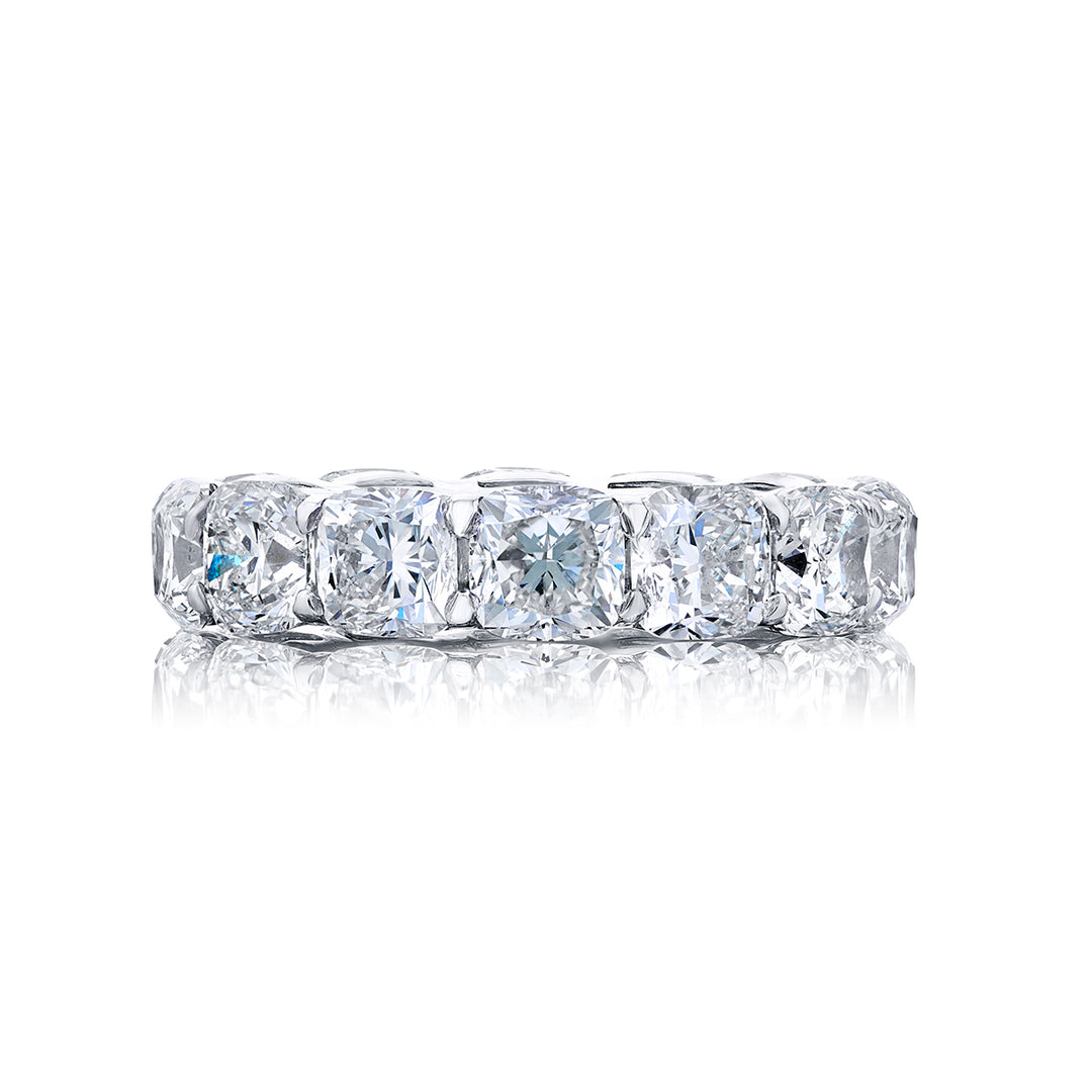 Alluring Eternity: Our beautiful single-row Diamond Eternity Band. This fourteen cushion-cut diamond ring is handcrafted in pure platinum.