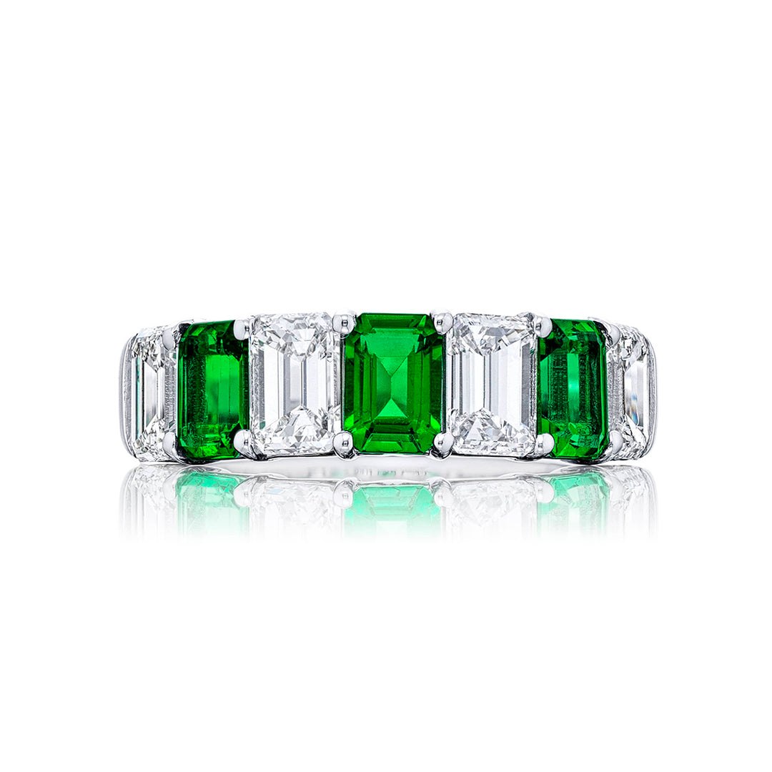 Gorgeous emerald and diamond wedding band featuring 4 perfectly matched emerald-cut diamonds and 3 emerald-cut emeralds in a shared prong setting. Handcrafted in pure platinum.