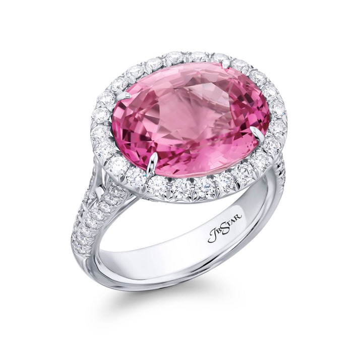 Breathtaking Radiance: Our magnificent 10.17 ct. certified Padparadscha Sapphire Ring. This stunning oval padparadscha sapphire embraced by tapered baguette and micro pave diamonds is handcrafted in pure platinum.