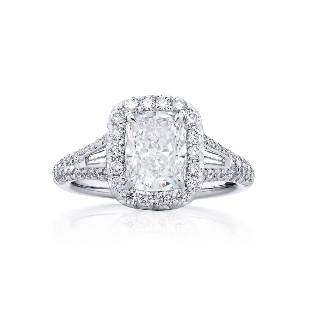 Dazzling Brilliance: Our timeless 1.50 ct. GIA certified Diamond Ring. This beautiful cushion-cut diamond cradled in tapered baguette and micro pave diamonds is handcrafted in pure platinum.