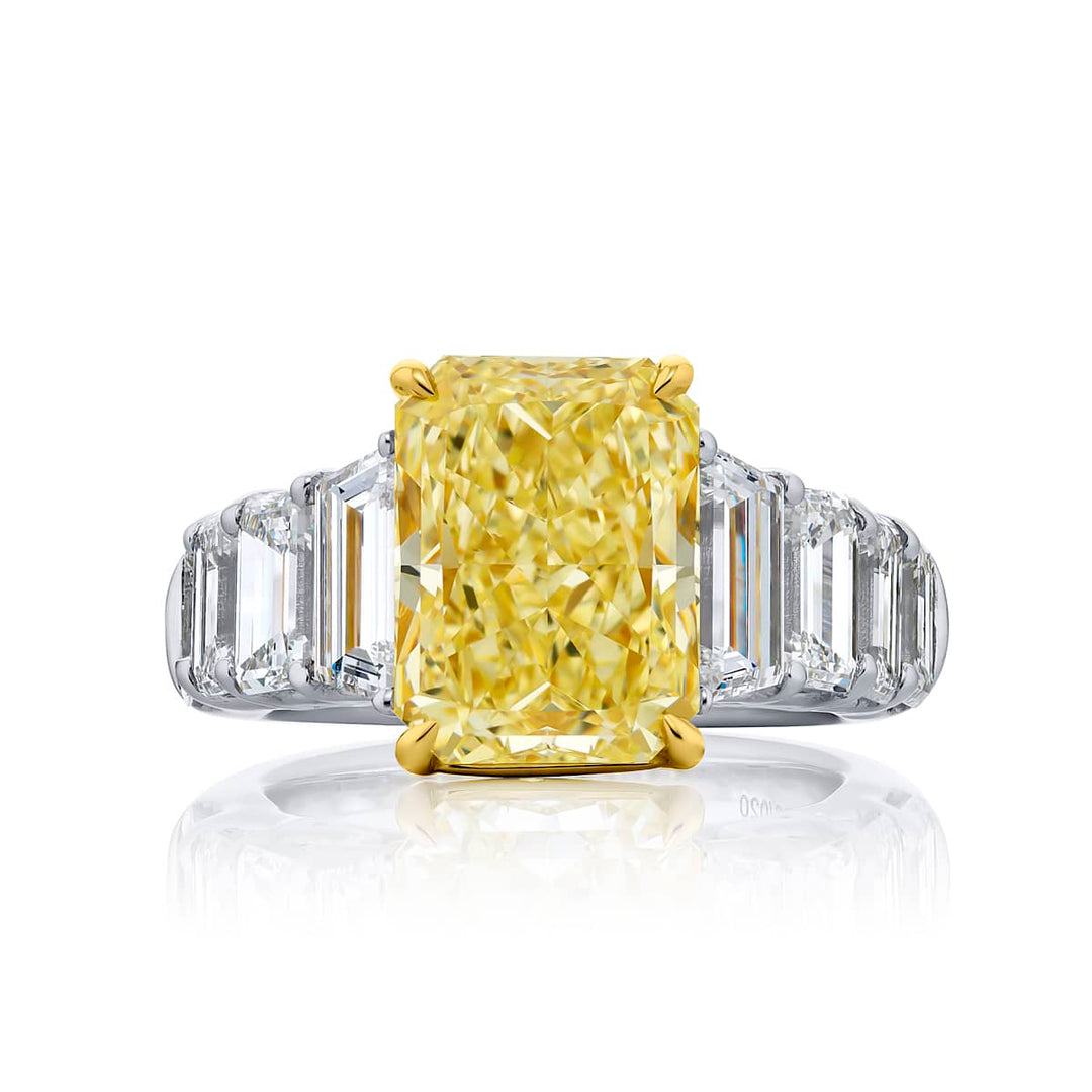 Dazzling Brilliance: Our magnificent 5.14 ct. GIA certified Fancy Yellow Diamond Ring. This beautiful radiant-cut fancy yellow diamond flanked by emerald-cut and tapered baguette diamonds is handcrafted in pure platinum and 18KY gold.