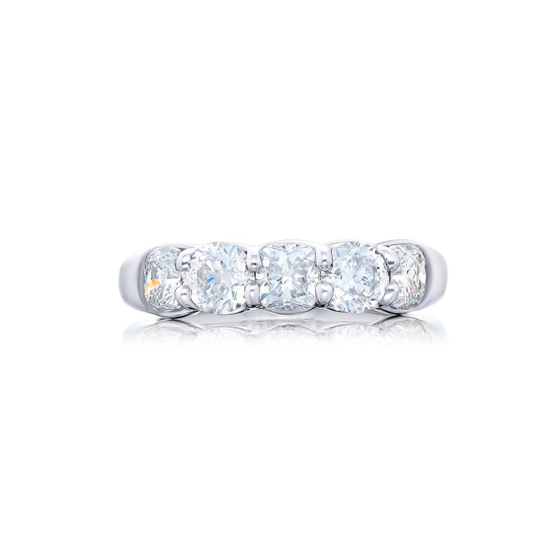 Elegance Elevated: Our classic single row Diamond Band. These stunning cushion-cut and round diamonds are handcrafted in pure platinum.