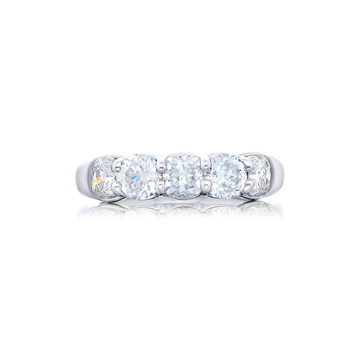 Elegance Elevated: Our classic single row Diamond Band. These stunning cushion-cut and round diamonds are handcrafted in pure platinum.