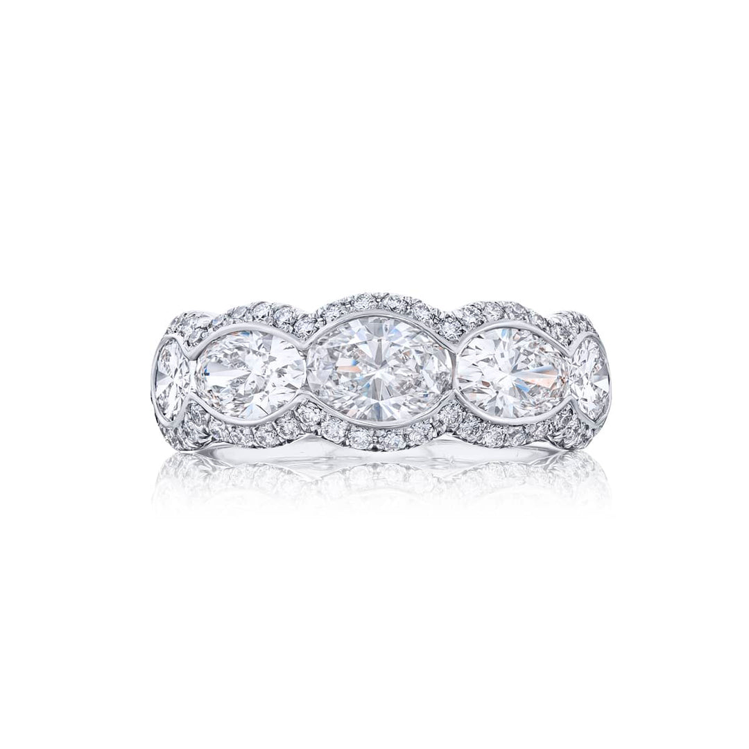 Elegance Elevated: Our signature East-West Bezel Diamond Band. These five gorgeous oval diamonds embraced by micro pave diamonds are handcrafted in pure platinum.