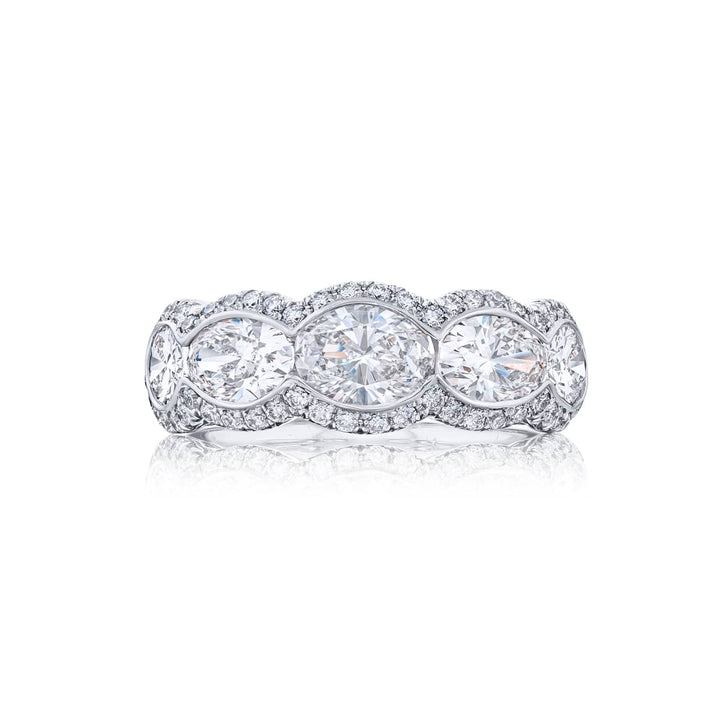 Elegance Elevated: Our signature East-West Bezel Diamond Band. These five gorgeous oval diamonds embraced by micro pave diamonds are handcrafted in pure platinum.