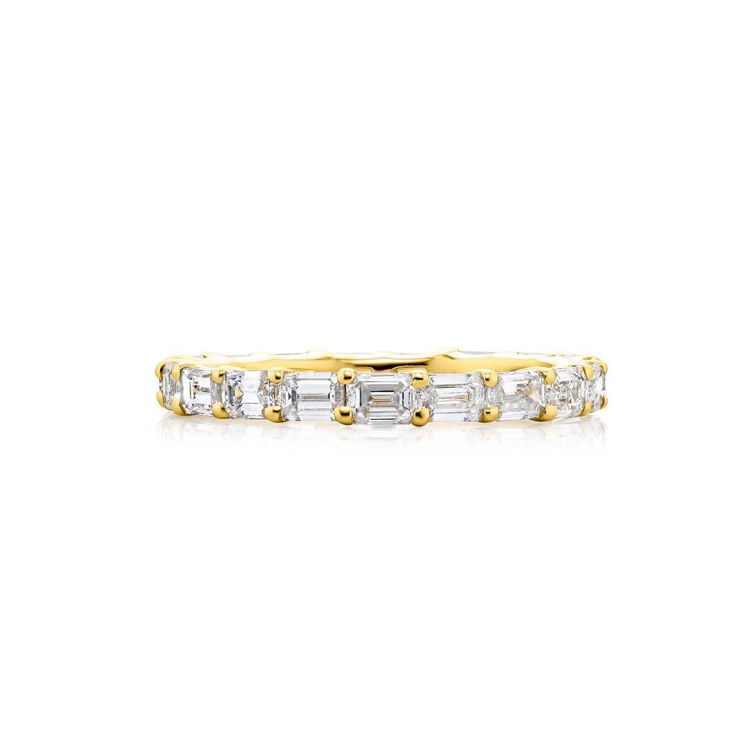 Alluring Eternity: Our stunning 2.28 ctw. East-West Diamond Eternity Band. These nineteen beautiful emerald-cut diamonds are handcrafted in 18KY gold.