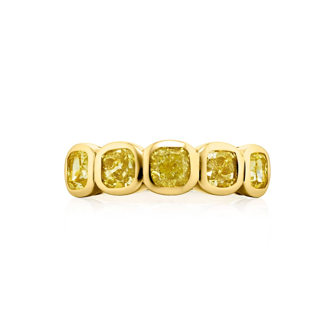 Elegance Elevated: Our stunning 2.31 ctw. Bezel Fancy Yellow Diamond Band. These five beautiful cushion-cut fancy yellow diamonds are handcrafted in 18KY gold.
