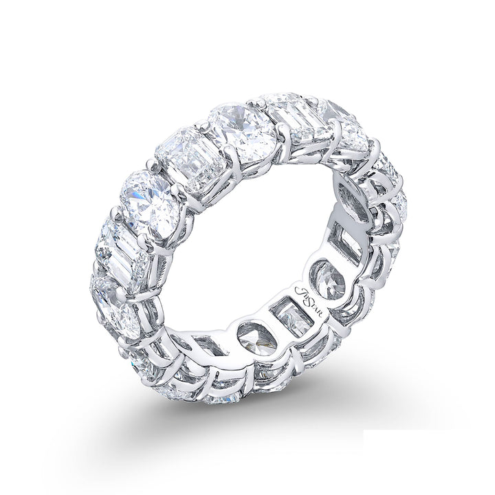 Stunning eternity band featuring 16 stones alternating between oval and emerald cut diamonds in shared prong setting. Handcrafted in pure platinum.