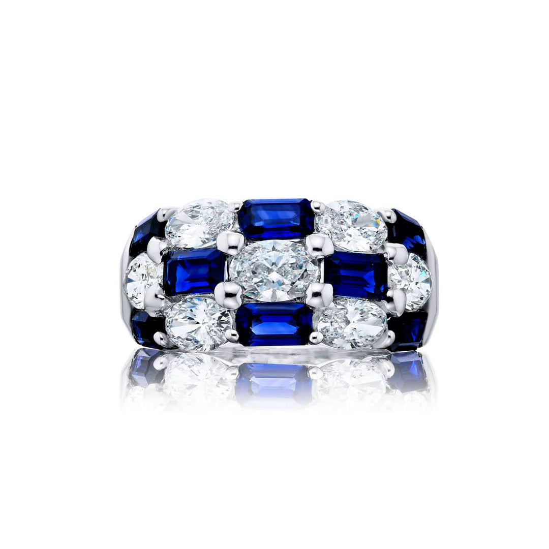 Elegance Elevated: Our signature Three-Row Sapphire Band. These gorgeous emerald-cut sapphires cradled in oval diamonds are handcrafted in pure platinum.