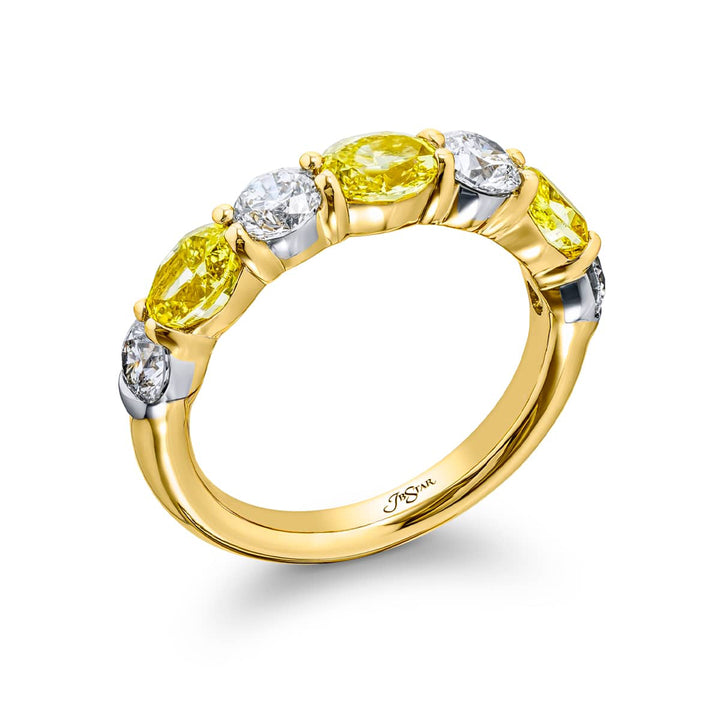 Elegance Elevated: Our classic single row East-West Fancy Yellow & White Diamond Band. These oval fancy yellow diamonds accompany round white diamonds and are handcrafted in 18KY gold.