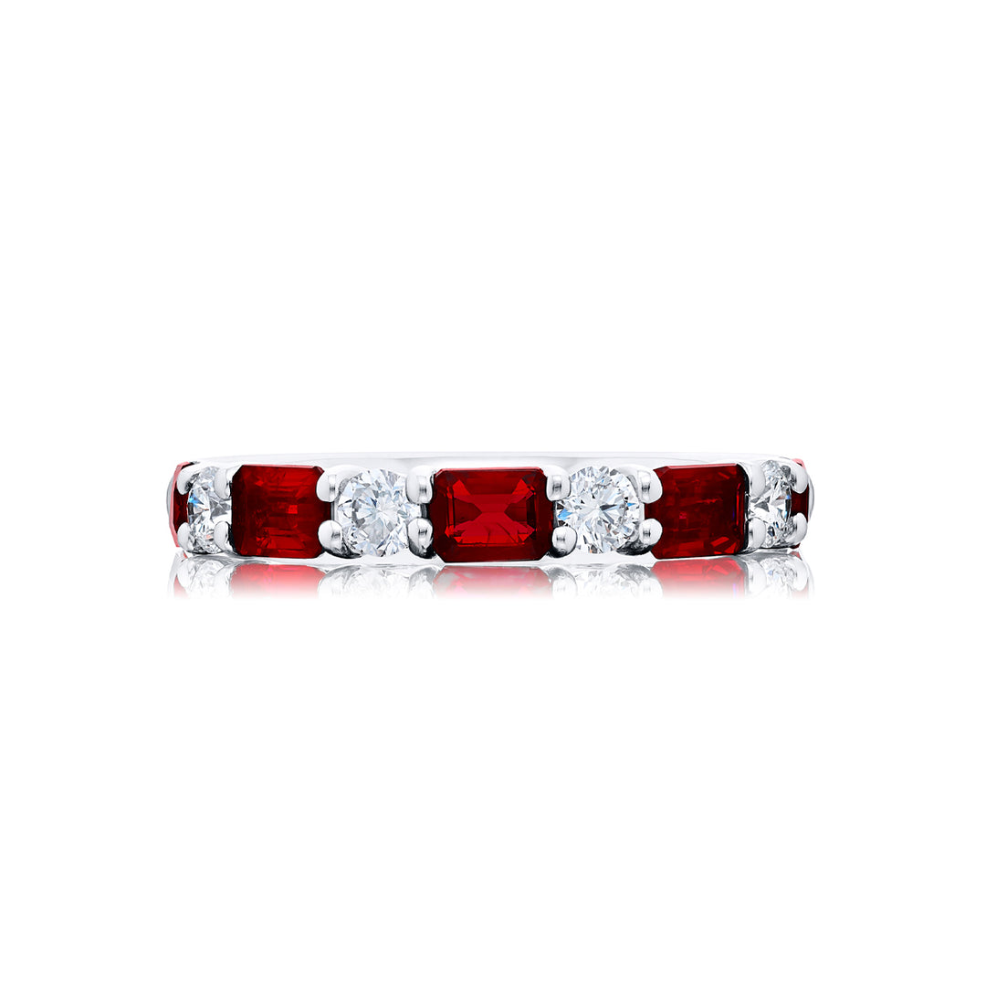 Elegance Elevated: Our classic single row East-West Ruby Band. These beautiful emerald-cut rubies blended with round diamonds are handcrafted in pure platinum.