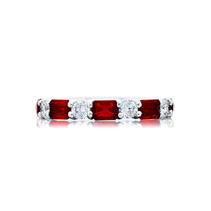 Elegance Elevated: Our classic single row East-West Ruby Band. These beautiful emerald-cut rubies blended with round diamonds are handcrafted in pure platinum.