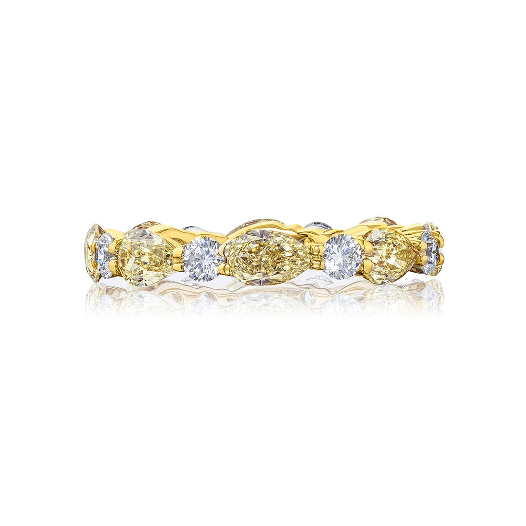Beautiful diamond eternity band featuring fancy yellow pear-shaped diamonds and round white diamonds in a shared prong setting. Handcrafted in 18KY gold.