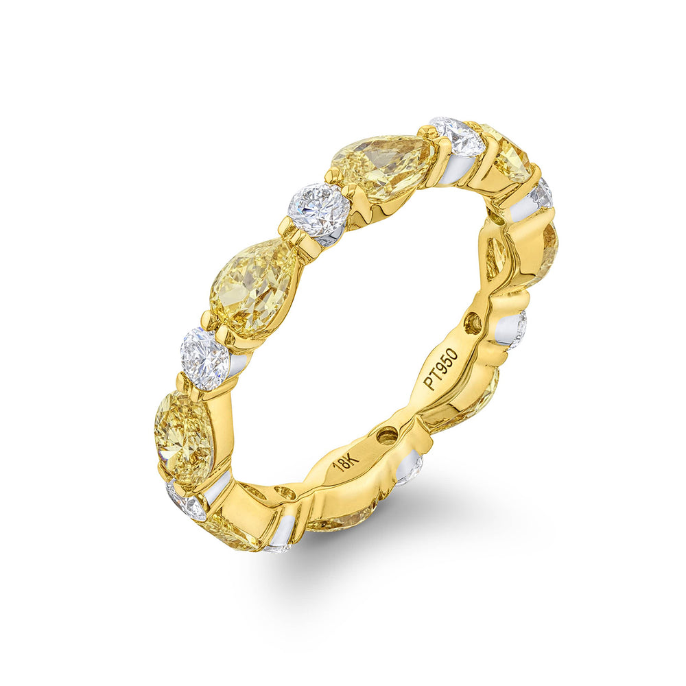 Beautiful diamond eternity band featuring fancy yellow pear-shaped diamonds and round white diamonds in a shared prong setting. Handcrafted in 18KY gold.