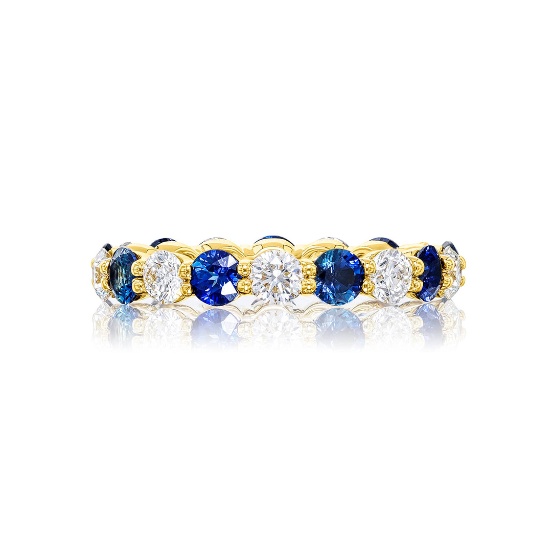 Alluring Eternity: Our beautiful single row Sapphire and Diamond Eternity Band. These stunning round sapphires blend with round diamonds and are handcrafted in 18KY gold.