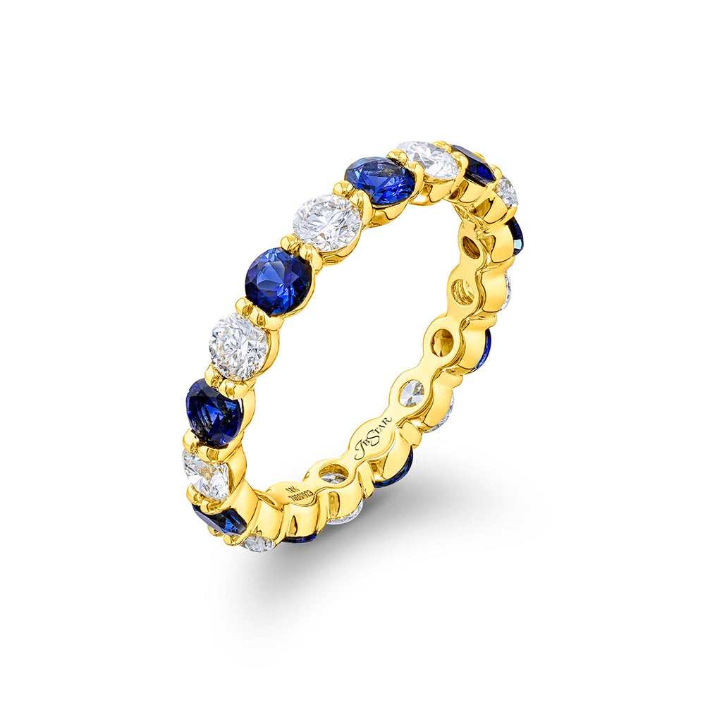 Alluring Eternity: Our beautiful single row Sapphire and Diamond Eternity Band. These stunning round sapphires blend with round diamonds and are handcrafted in 18KY gold.