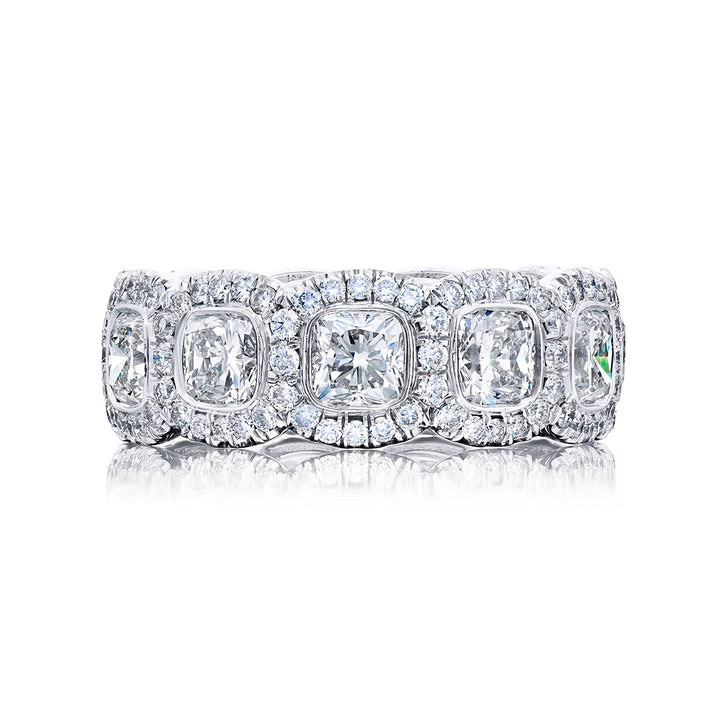 Alluring Eternity: Our stunning single-row Bezel Set Diamond Eternity Band. These eleven cushion-cut diamonds embraced by micro pave diamonds are handcrafted in pure platinum.