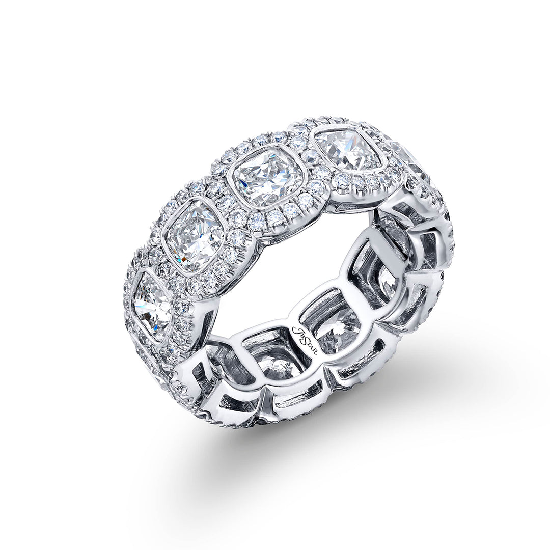 Alluring Eternity: Our stunning single-row Bezel Set Diamond Eternity Band. These eleven cushion-cut diamonds embraced by micro pave diamonds are handcrafted in pure platinum.