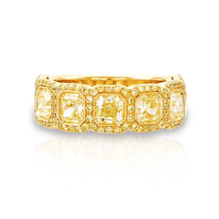 Elegance Elevated: Our classic 2.73 ctw. Bezel Pave Diamond Band. These seven beautiful radiant-cut fancy yellow diamonds embraced by fancy yellow pave diamonds are handcrafted in 18KY gold.
