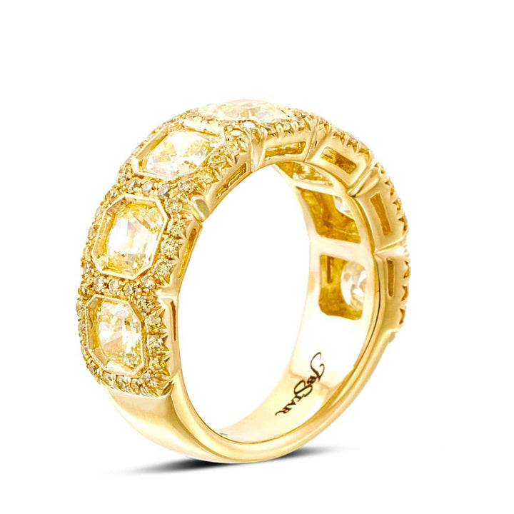 Elegance Elevated: Our classic 2.73 ctw. Bezel Pave Diamond Band. These seven beautiful radiant-cut fancy yellow diamonds embraced by fancy yellow pave diamonds are handcrafted in 18KY gold.