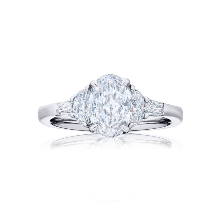 Dazzling Brilliance: Our timeless 1.50ct GIA-certified diamond ring. This oval-cut diamond is flanked by half-moon diamonds and tapered baguettes meticulously handcrafted in pure platinum.