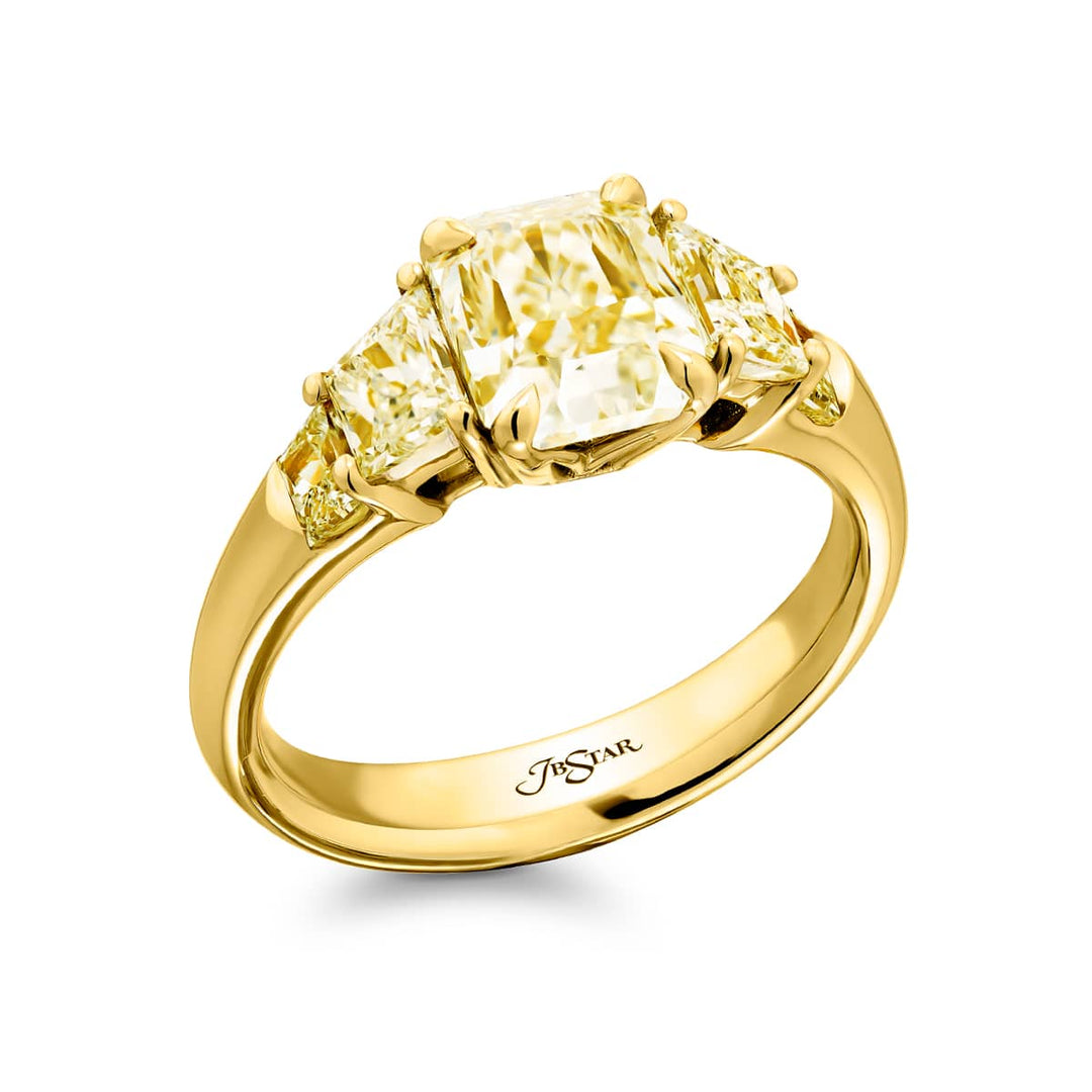 Dazzling Brilliance: Our timeless 1.64 ct. GIA certified Fancy Yellow Diamond Ring. This gorgeous radiant-cut fancy yellow diamond flanked by trapezoid fancy yellow diamonds is handcrafted in 18K yellow gold.