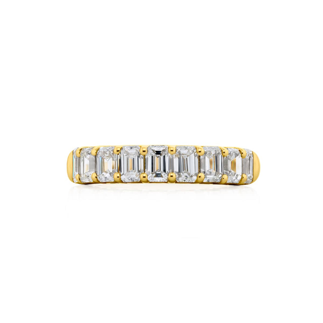 Elegance Elevated: Our classic 1.73 ctw. Diamond Band. These nine beautiful emerald-cut diamonds are handcrafted in 18KY gold.