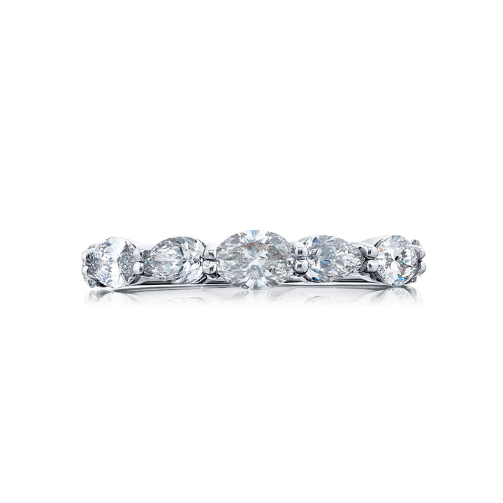 Elegance Elevated: Our timeless single-row East-West Diamond Band. This beautiful oval diamond blends with square emerald-cut and marquise diamonds and are handcrafted in pure platinum.
