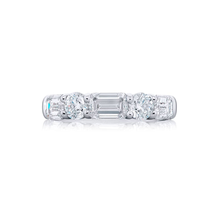 Elegance Elevated: Our classic 3.03 ctw. East-West single row Diamond Band. These beautiful emerald-cut diamonds accompany round diamonds and are handcrafted in pure platinum