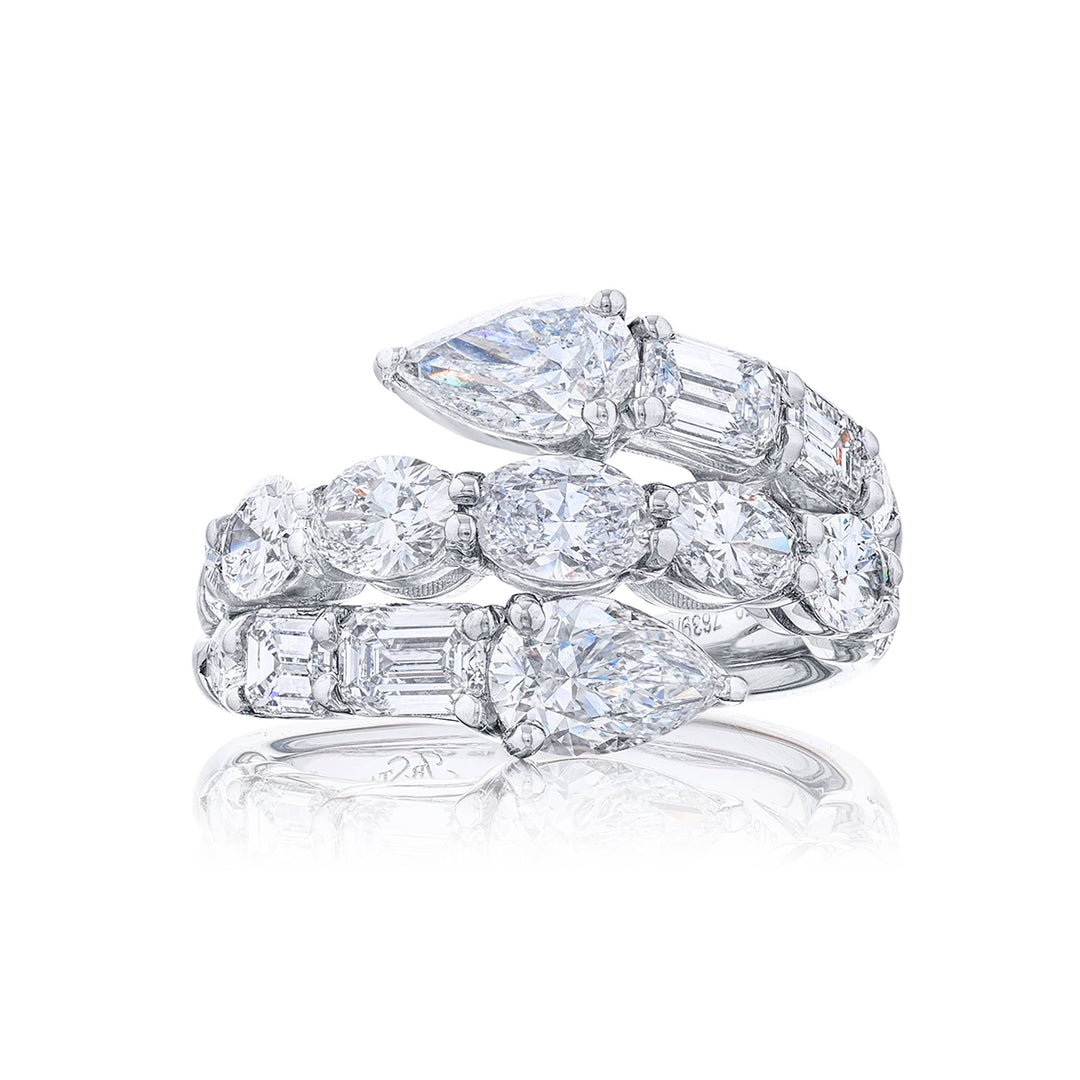 Dazzling three row diamond ring featuring pear shaped emeraldand and oval diamonds in a stunning design. Handcrafted in pure platinum.