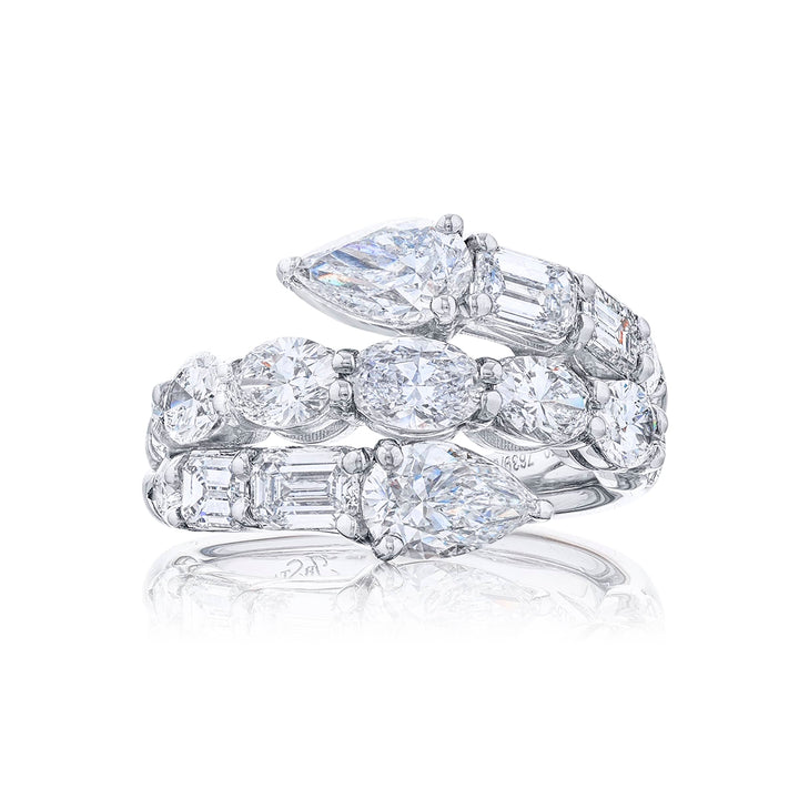 Dazzling three row diamond ring featuring pear shaped emeraldand and oval diamonds in a stunning design. Handcrafted in pure platinum.