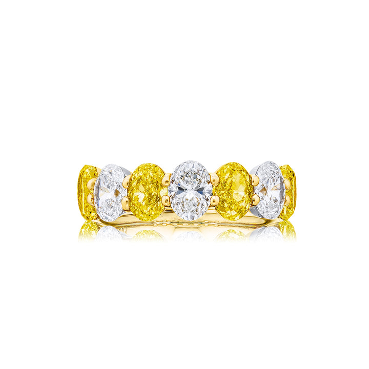 Elegance Elevated: Our classic single row Fancy Yellow & White Diamond Band. These stunning oval fancy yellow diamonds accompany oval white diamonds and are handcrafted in 18KY gold.