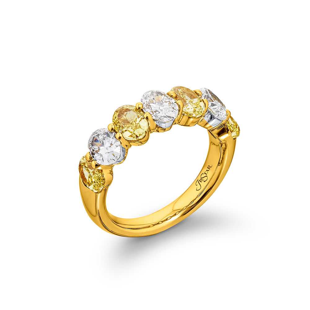 Elegance Elevated: Our classic single row Fancy Yellow & White Diamond Band. These stunning oval fancy yellow diamonds accompany oval white diamonds and are handcrafted in 18KY gold.