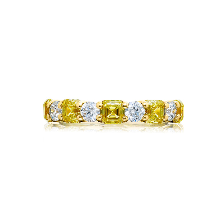 Elegance Elevated: Our classic single row East-West Fancy Yellow & White Diamond Band. These stunning square emerald-cut fancy yellow diamonds accompany round white diamonds and are handcrafted in 18KY gold.