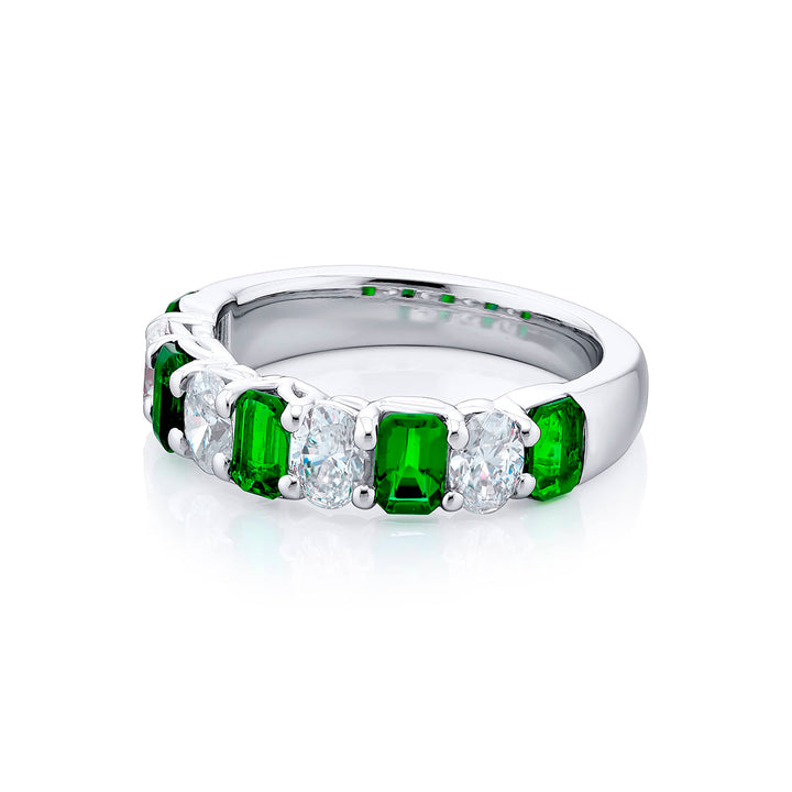 Elegance Elevated: Our classic single row Emerald Band. These beautiful emerald-cut emeralds blended with oval diamonds are handcrafted in pure platinum.