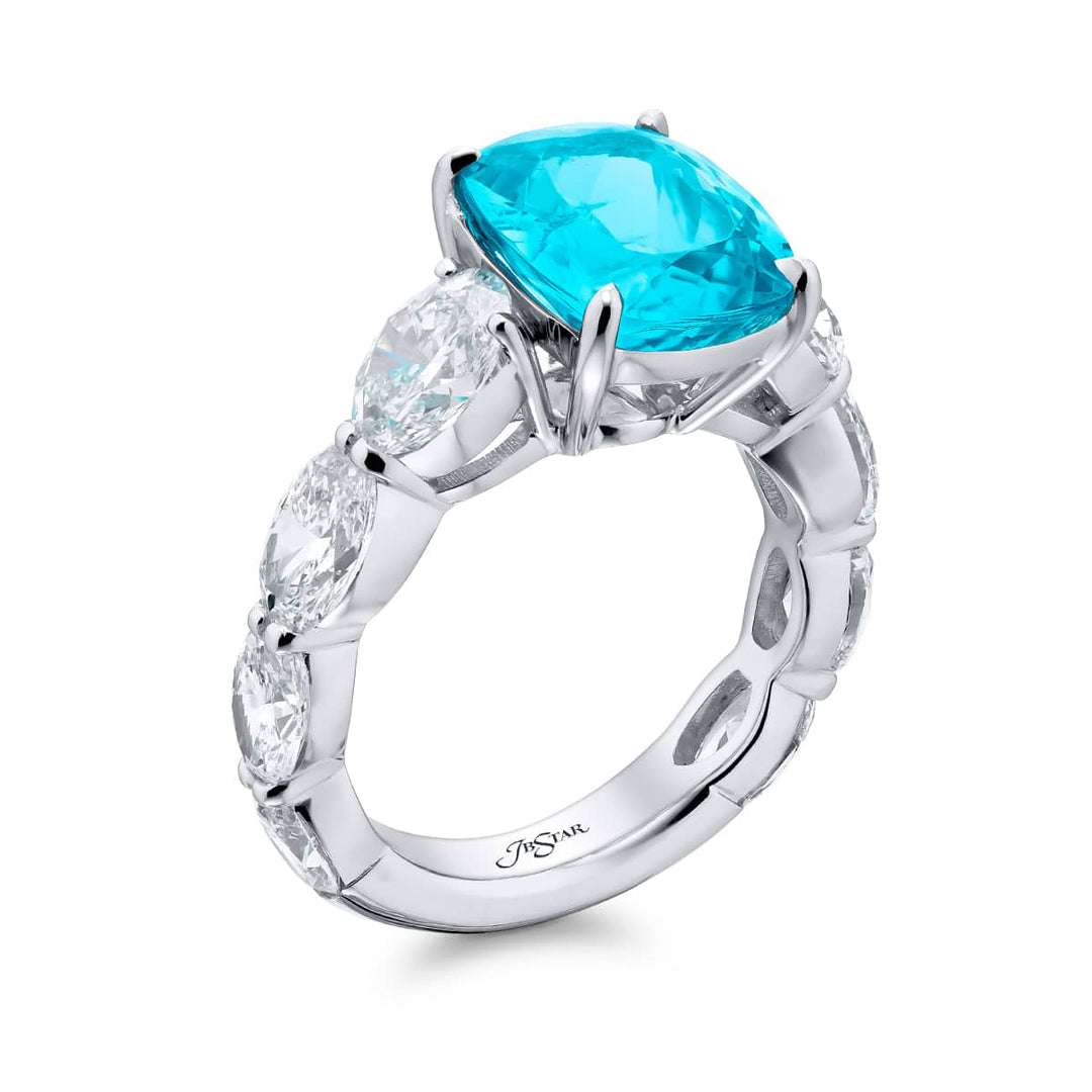 Breathtaking Radiance: Our beautiful 4.23 ct. certified Paraiba Ring. This stunning cushion-cut paraiba flanked by dazzling oval diamonds is handcrafted in pure platinum.