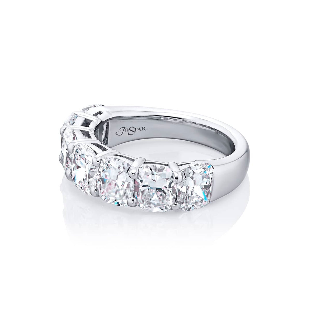 Elegance Elevated: Our stunning 4.96 ctw. GIA certified Diamond Band. These seven beautiful cushion-cut diamonds are handcrafted in pure platinum.